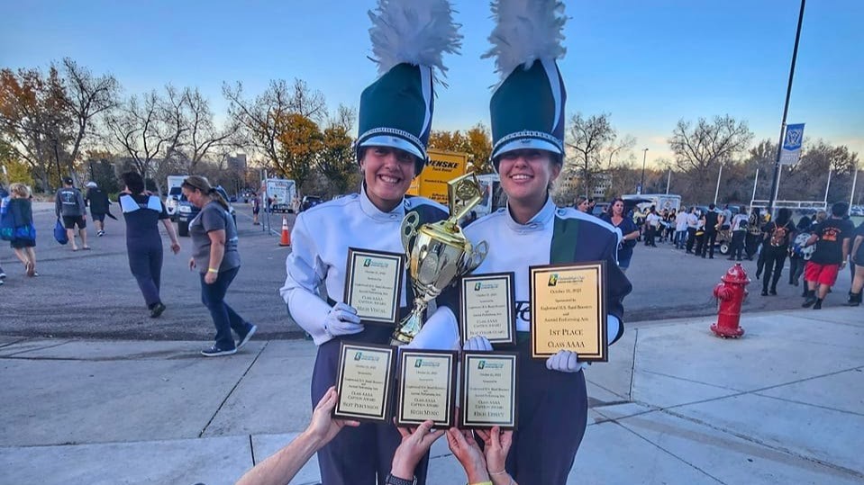 Students holding plaques